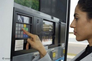 Lady inputting her code at gas pump
